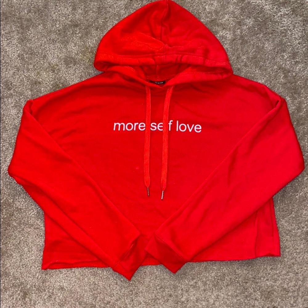 A red hoodie that says more self love ❤️